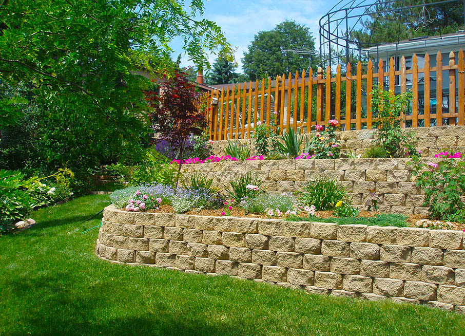 Terraced retaining wall with colorful flowers, plants, and trees